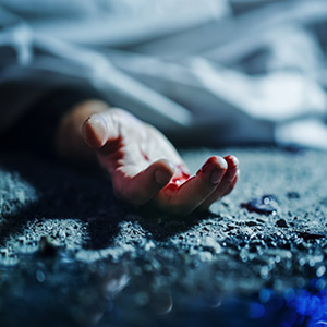A bloody hand on the ground, symbolizing a serious crime requiring a manslaughter lawyer.